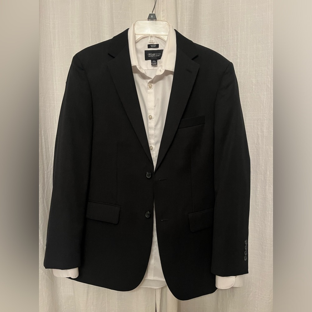 Men’s black wool suit with white shirt and green tie